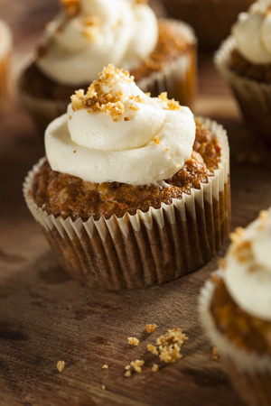 27140340 - homemade carrot cupcakes with cream cheese frosting for easter